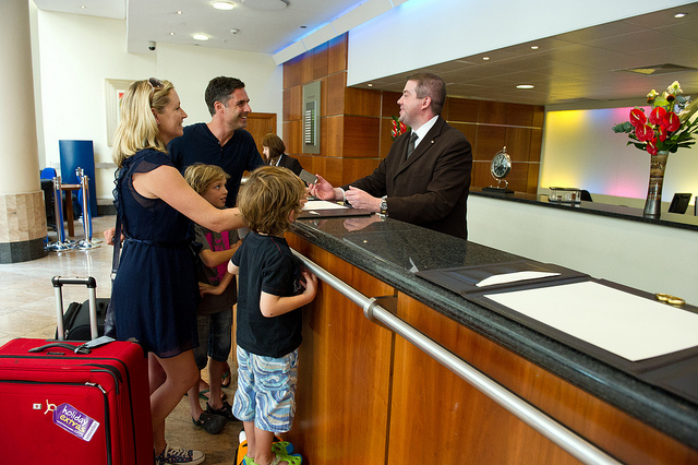 family at hotel front desk