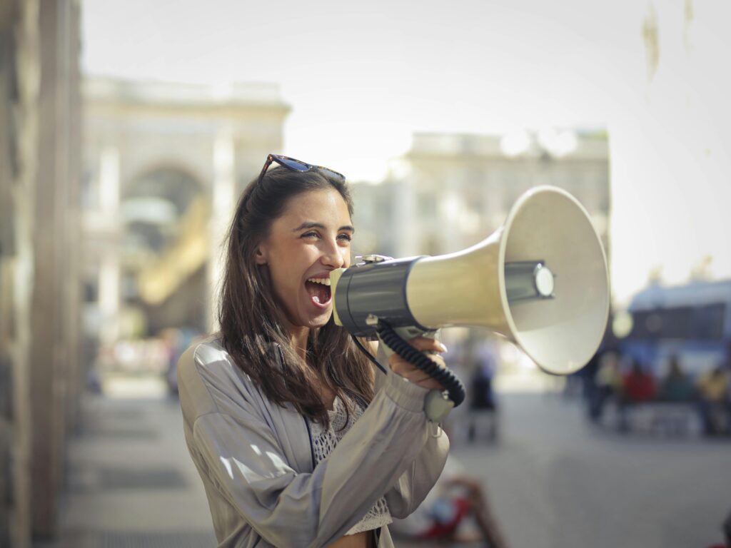 Cheerful young woman screaming the Top Hotel Marketing Myths